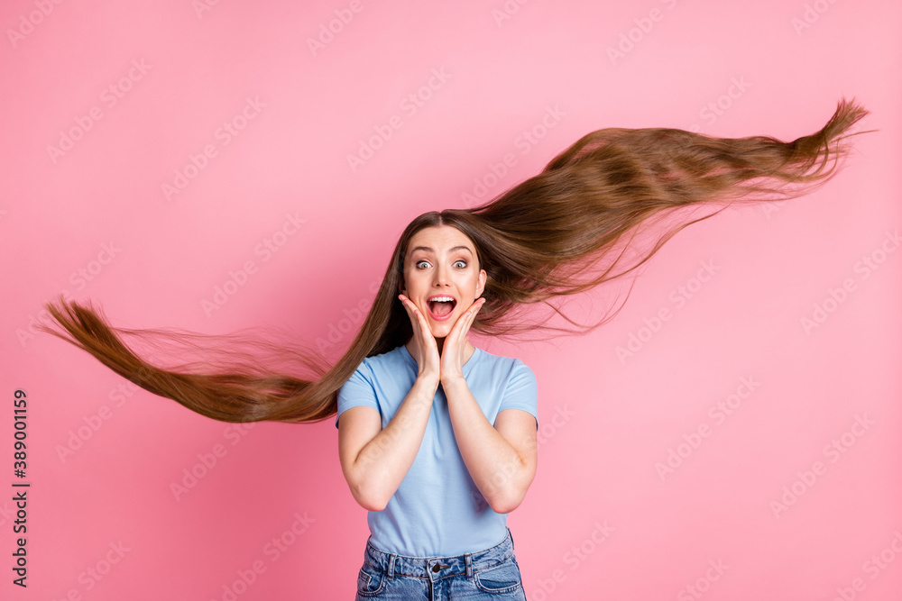 Canvas Prints photo portrait of girl with flying hair touching face with two hands isolated on pastel pink colored