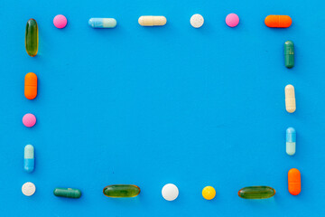Fototapeta na wymiar A lot of colorful medication pills drugs, top view