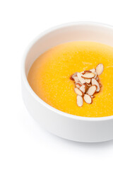 Bowl of pumpkin soup isolated on white