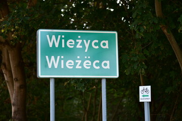 Wiezyca village road information sign in Kashubian language. Endangered language in the UNESCO list.