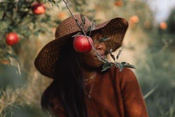 Portrait Afro woman in Apple Orchard. African ethnicity. Lifestyle