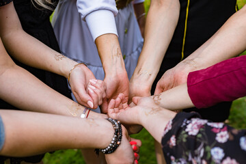Hands of the bride and bridesmaids at the hen party