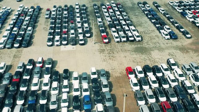 Aerial view of new cars in car factory parking lot. Automobile, cars dealer parking lot.