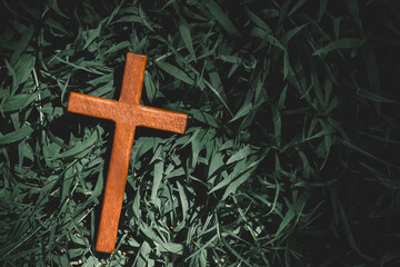 cross put on grave surrounded by grass. marker standing alone. Crucifixion Of Jesus Christ....