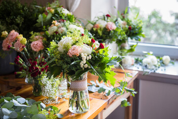 Fototapeta na wymiar Bouquets of flowers in a floristic studio (flower shop)
