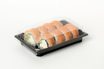 Philadelphia rolls delivered in plastic container, food delivery service concept