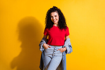 Photo of young charming girl hands pockets wear red top striped jeans jacket isolated yellow color background