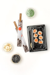 Food delivery concept, sushi in plastic container delivered to home