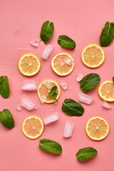 Composition with cut citrus fruits on pink background. Creative summer background composition with lemon slices, leaves mint and ice cubes. Minimal top down lemonade drink concept.Top view