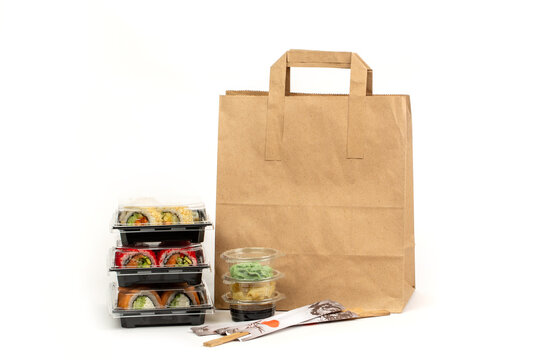 Food delivery concept, sushi in plastic container delivered to home