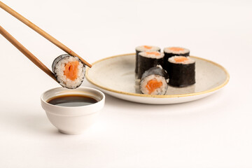 Roll with salmon on white background