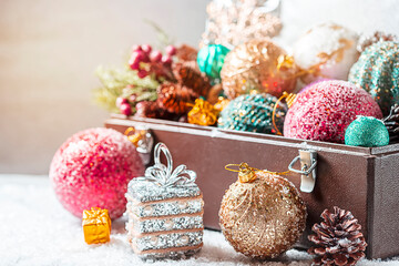 Leather suitcases in retro style full of Christmas tree decorations. Christmas holiday concept.