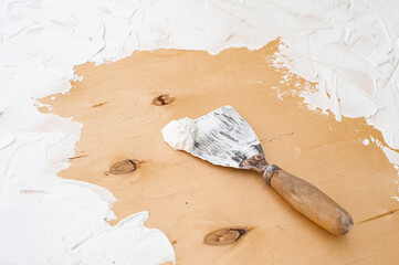 putty knife and plaster
