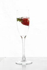 Filling up the champagne glass with strawberry isolated on a white background copy space