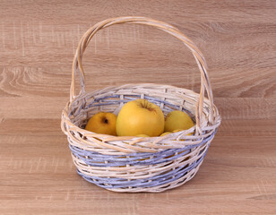 Basket with ripe fruits on a wooden table