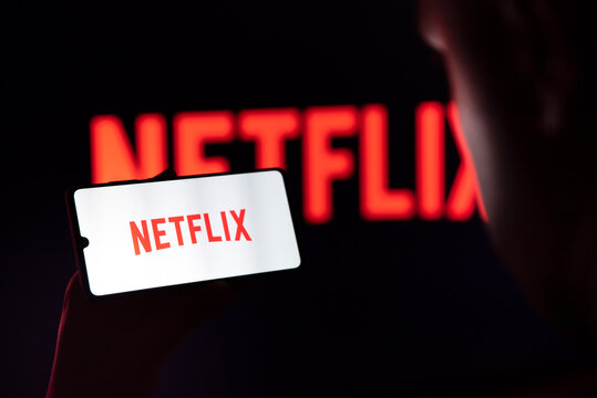 Man With Netflix Logo On Screen