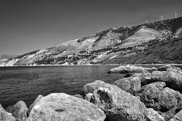 Boulders and windmills of the mountainous sea shore on the island of Kefalonia
