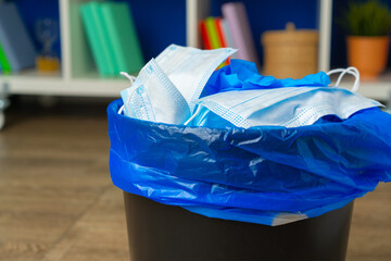 Used infectious masks and medical glove in the trash bin