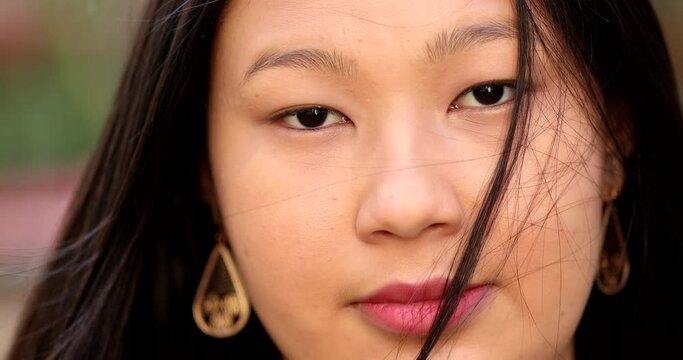 Asian young larger woman close-up face looking at camera