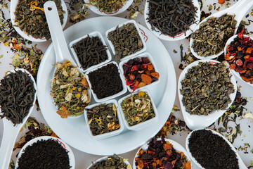 Assortment of dry tea. Various kinds of tea isolated on white.Different kinds of tea leaves. Tea composition with different kind of tea. Tea concept. Tea leaves