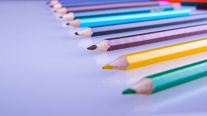 Colored pencils on a white background, copy space, isolated, close-up, side view