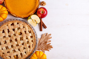 Two traditional American Thanks Giving pies with apples, mini pumpkins & cinnamon sticks. Homemade...