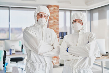 Portrait of two technicians in protective workwear in the office