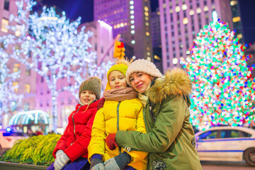 Happy family on the background of the Rockefeller Christmas tree in New York