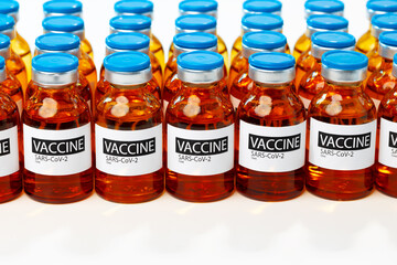 Sars-cov-2 vaccine vial bottles on white table