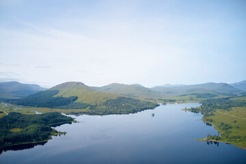 Mindfulness calm background banner of aerial view from above loch at sunrise in Scotland