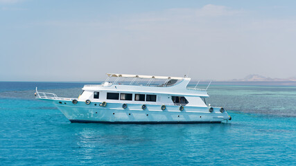 White private motor yacht in the blue sea