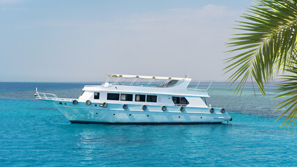 White private motor yacht in the blue sea