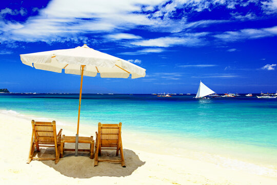 Tropical beach with sunshade and chairs