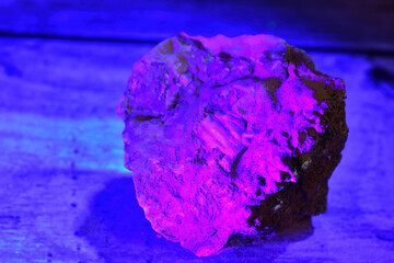 Mineral fluorescing pink under a UV light.