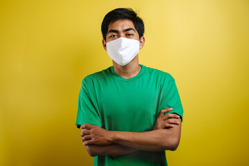 Portrait of young Asian man wearing protective mask against the coronavirus