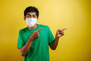 Portrait of young Asian man wearing protective mask against the coronavirus