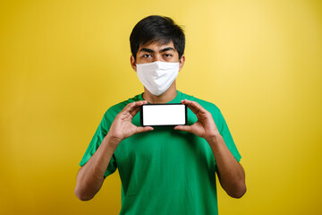 Portrait of young Asian man wearing protective mask against the coronavirus