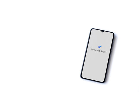 Lod, Israel - July 8, 2020: Microsoft To Do app launch screen with logo on the display of a black mobile smartphone isolated on white background. Top view flat lay with copy space.
