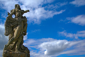 Fototapeta na wymiar Romantic stone statue with the sky in the background