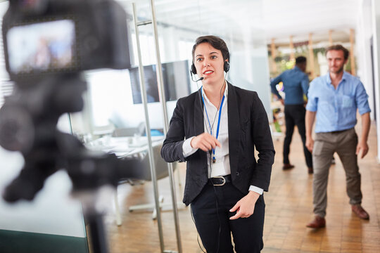 Business woman with headset while recording video