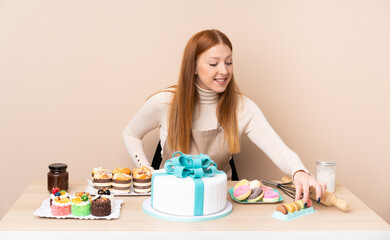 Obraz na płótnie Canvas Young redhead woman with a big cake