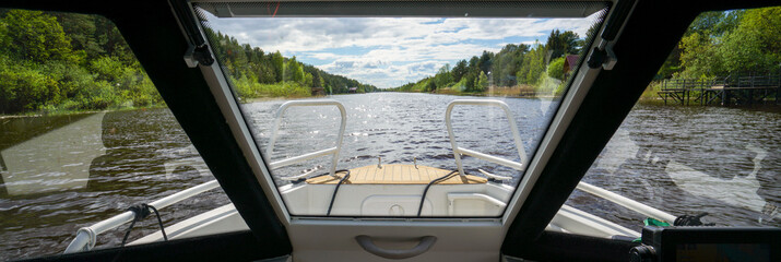 View from the cabin of the boat on the river in summer