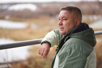 a man stands near an abandoned Marina on a cold cloudy day
