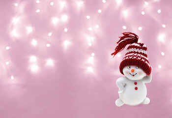 Snowman, toy on pink christmas background