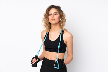 Young sport woman isolated on white background with jumping rope