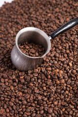 Cup of coffee on the coffee beans background
