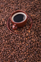Cup of coffee on the coffee beans background
