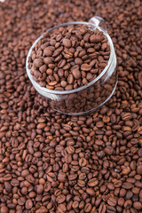 Cup of coffee on the coffee beans background