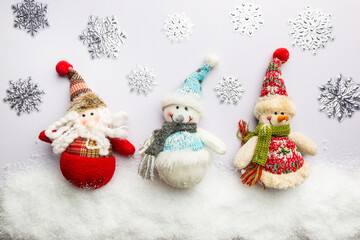 Happy holiday toys snowman and santa claus standing in winter christmas background. Christmas concept. Flat lay, top view.