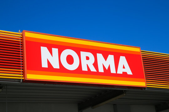 Heinsberg, Germany - March 23. 2020: Close up of isolated sign of german Norma food discounter chain against clear blue sky